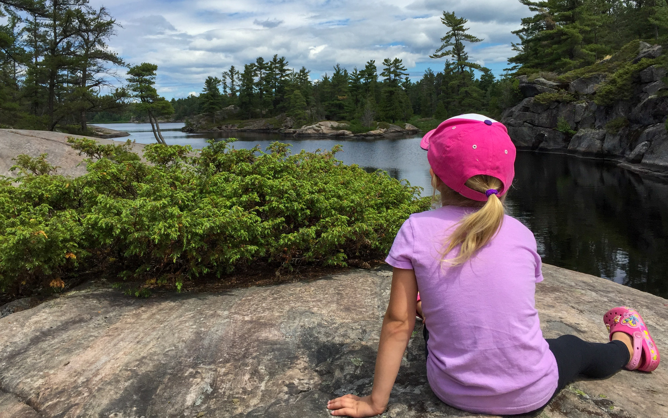 A little girl looking out at the water.