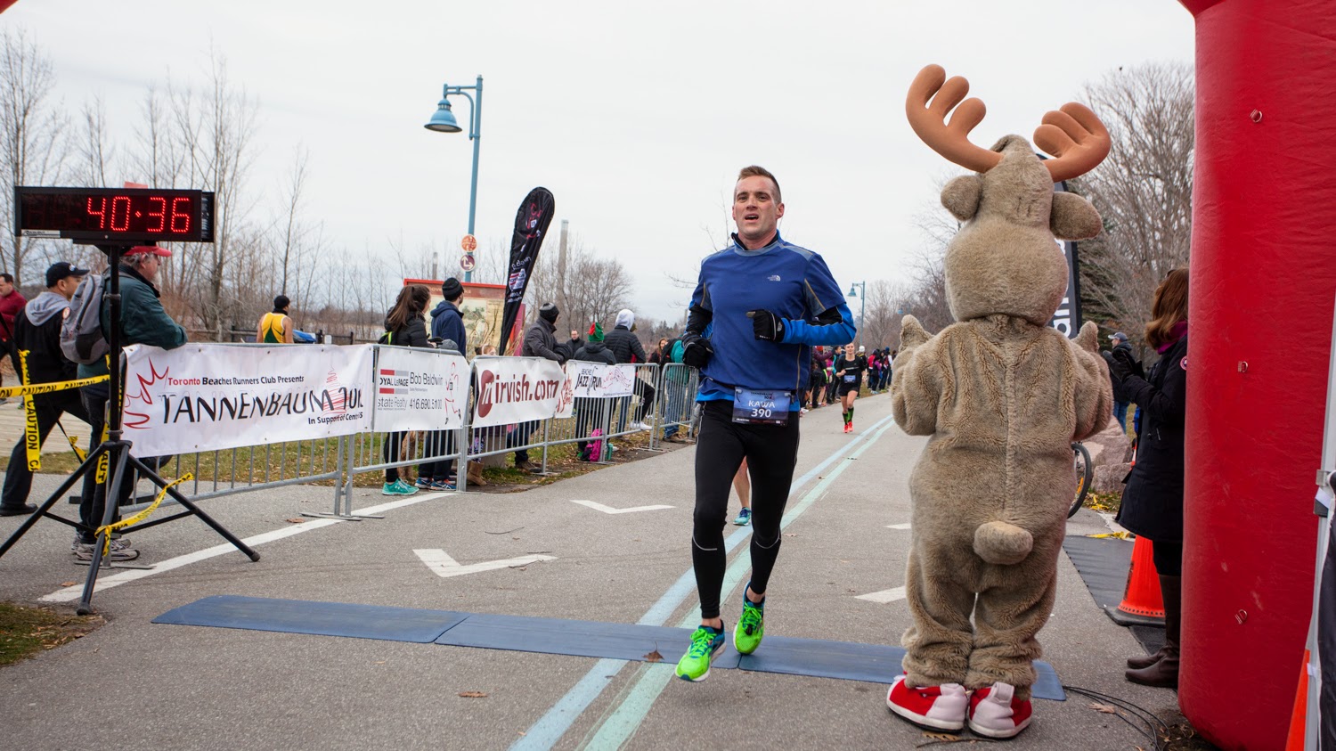 Crossing the finish line at the 2016 Tannenbaum 10k at the 40:36 mark, setting my 10k PB at 40:29