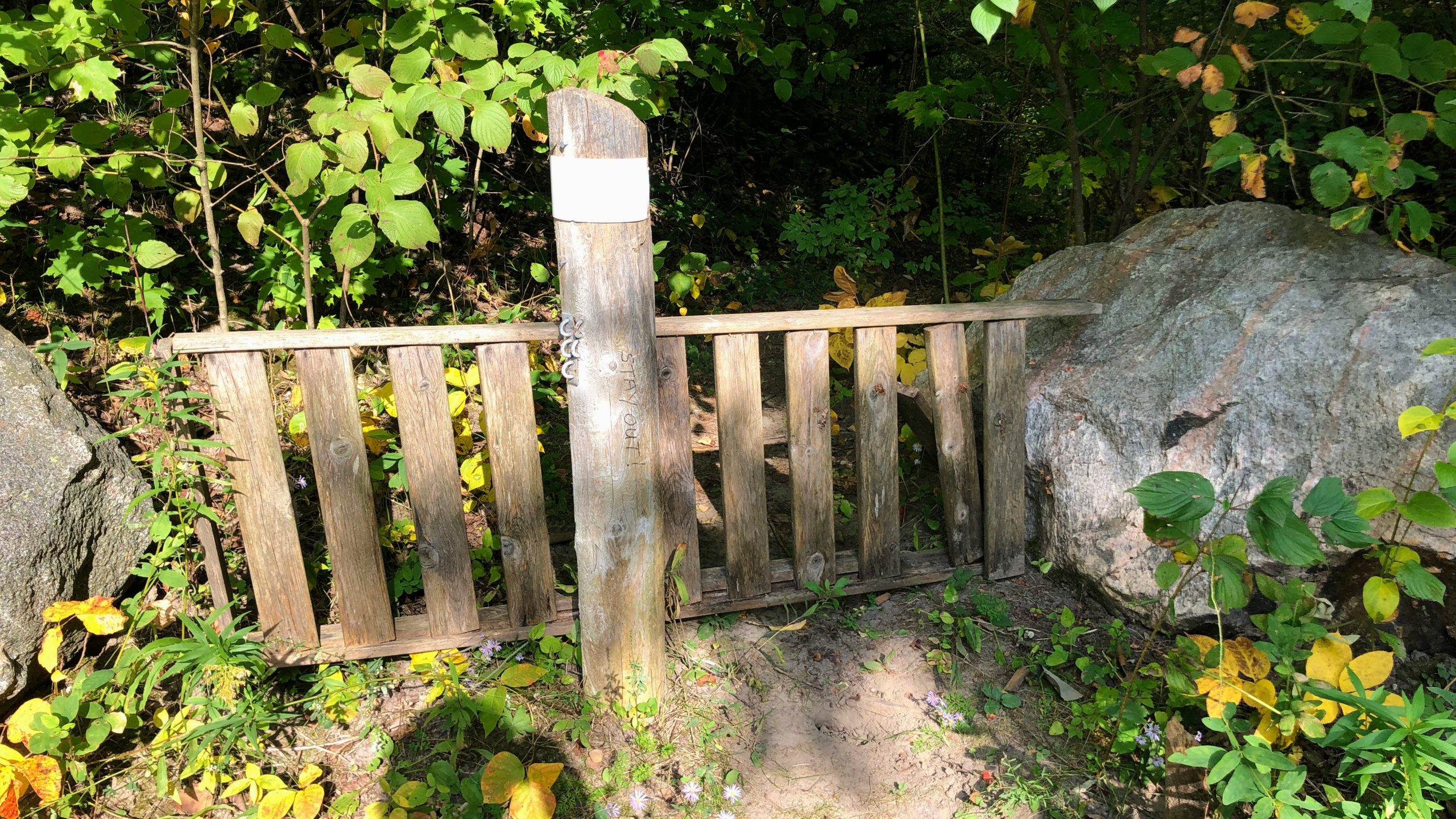 A trail block and writing telling me to stay out after climbing Crow's Passage.