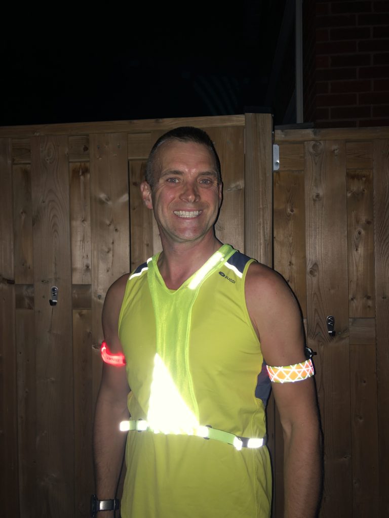 My setup for safe night running including two flashing arm bands, and a high visibility reflective vest.