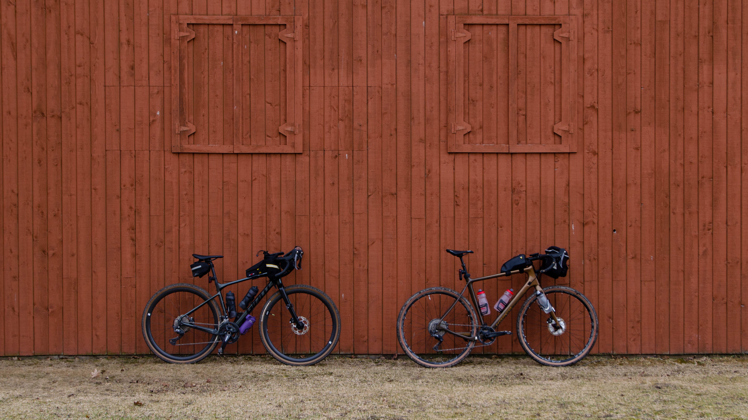 Photo of our gravel bikes against an brownish orange barn in Elgin Park Uxbridge.