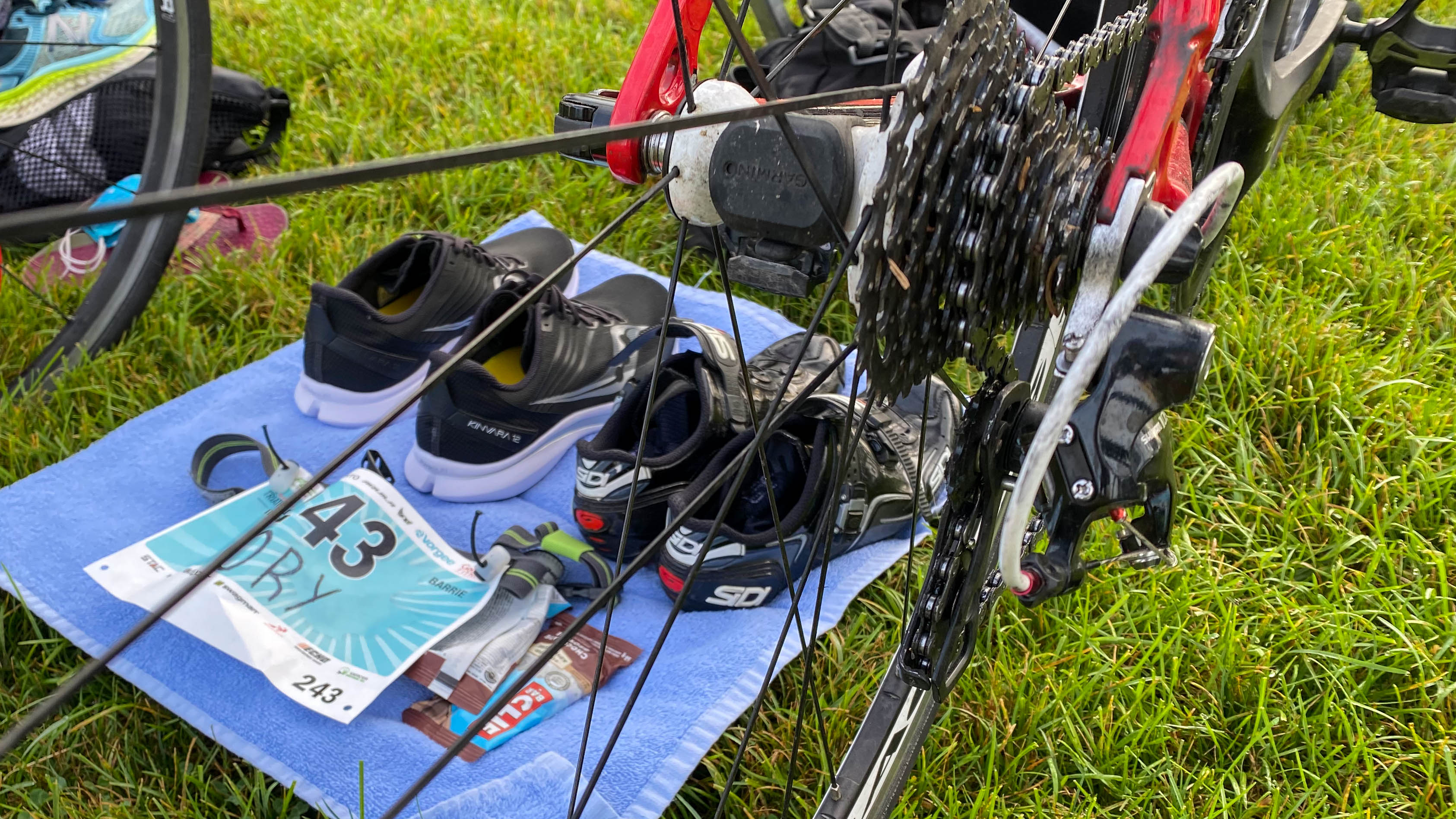 Setting up transition with shoes, towels, fuel, and race belt.