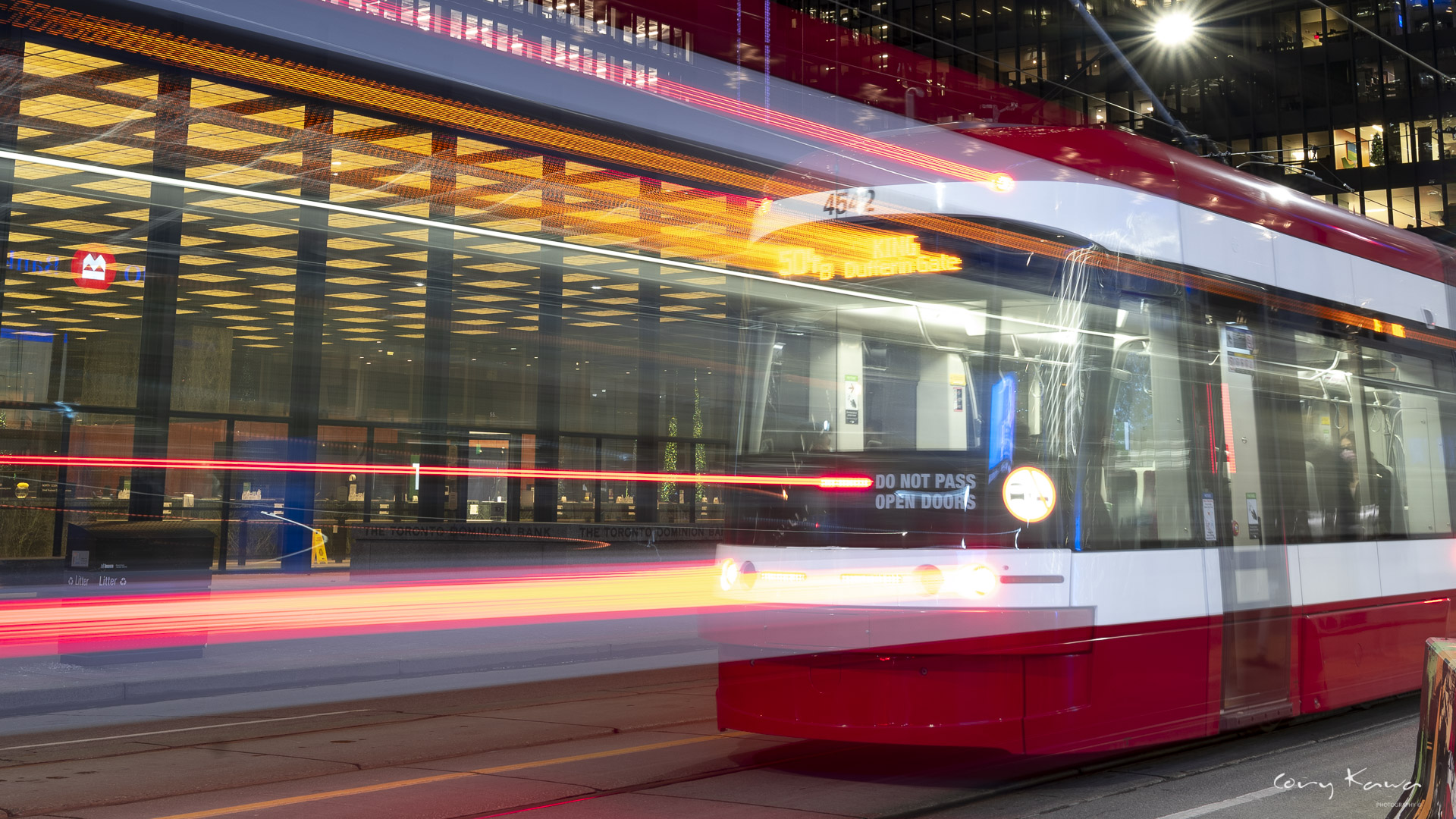 Long exposure of a TTC streetcar with light trails following behind