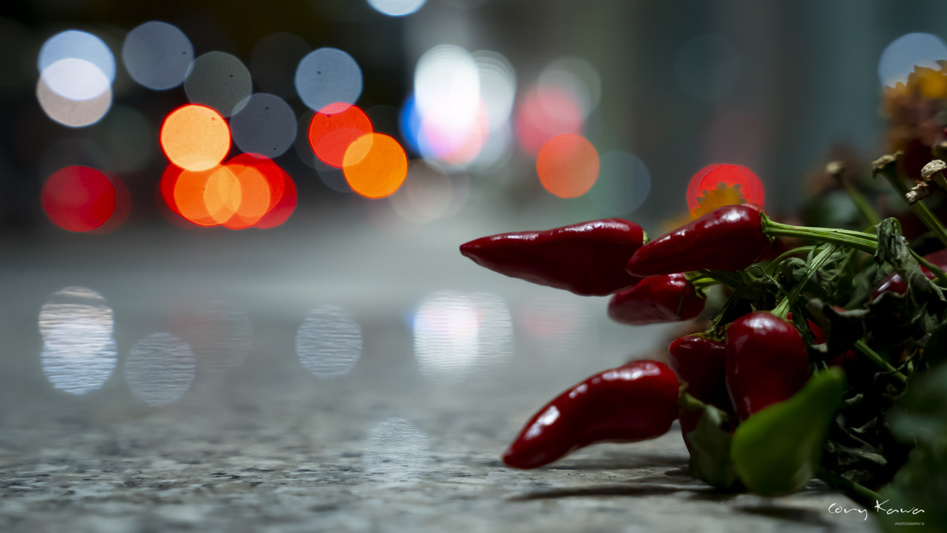Red hot pepper with multicolored lights blurred in the background