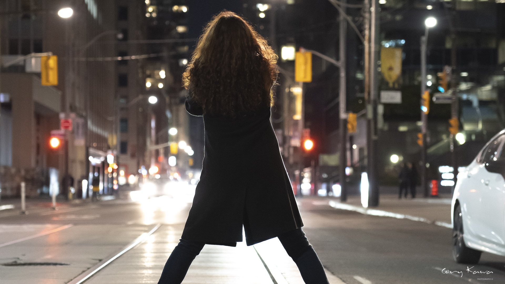 A lady framed by headlights