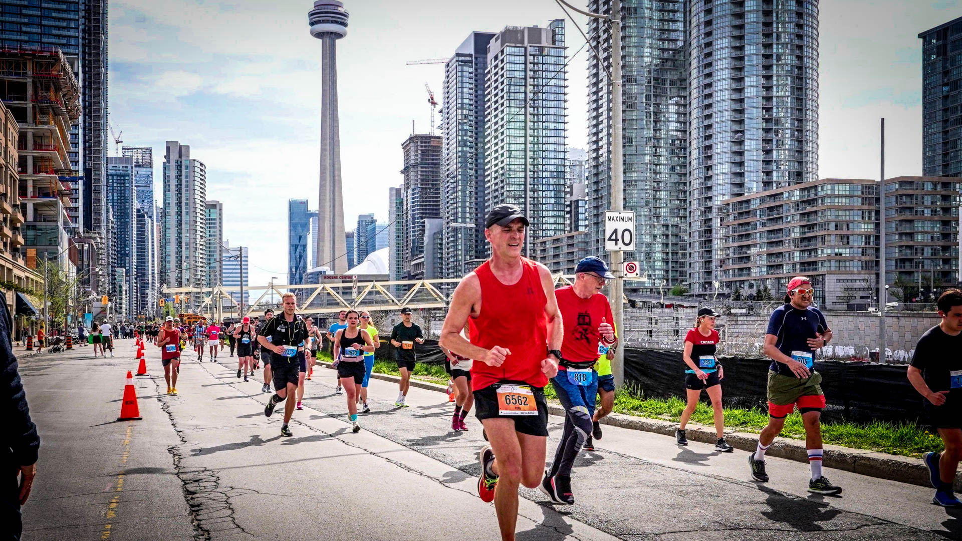 Running along Front St. with the CN Tower in the background at the 2023 Toronto Marathon.