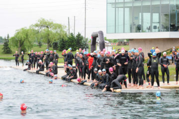 A group of swimmers lined up on the dock at the Welland Flat Water Centre.