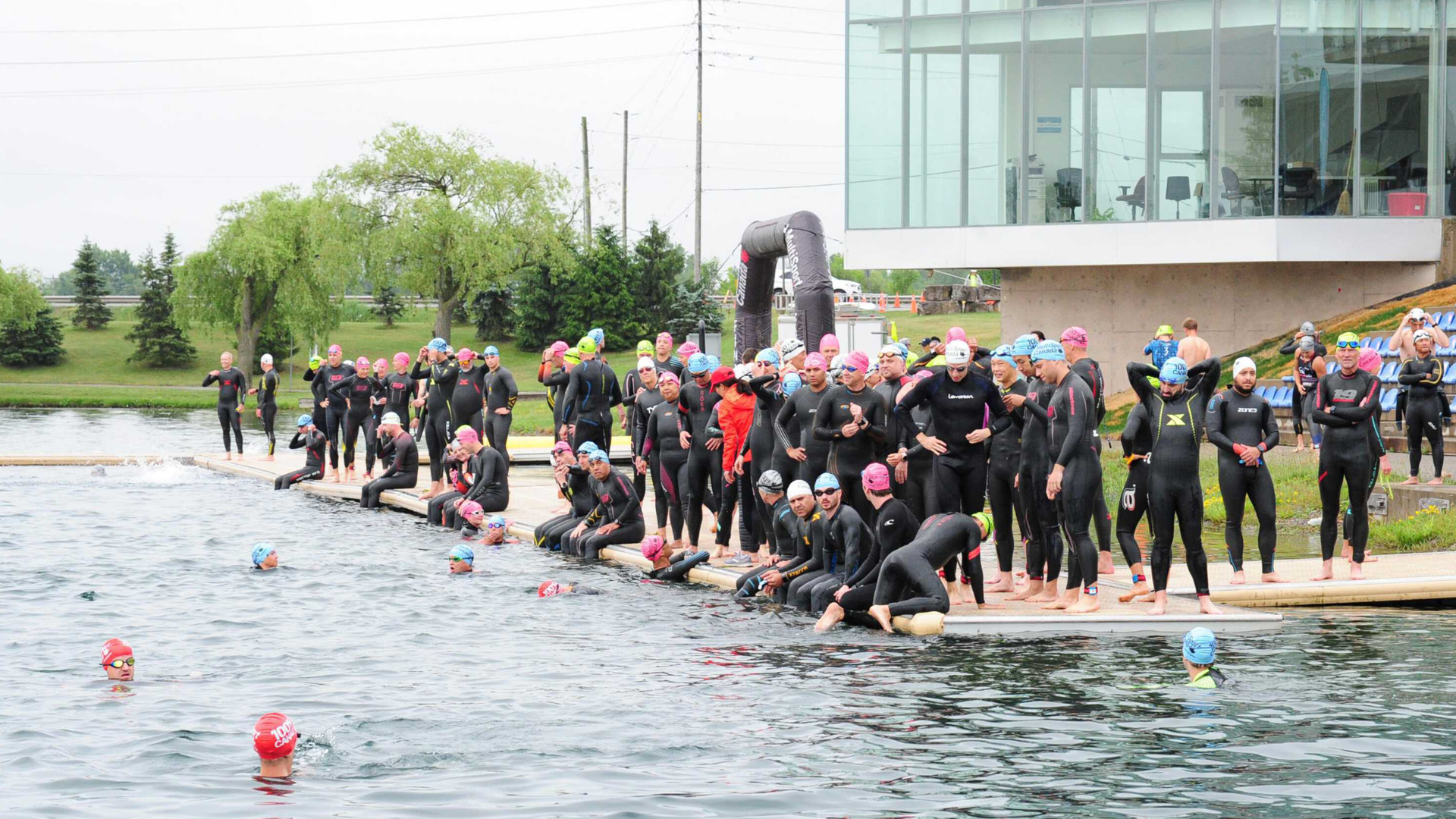 A group of swimmers lined up on the dock at the Welland Flat Water Centre.