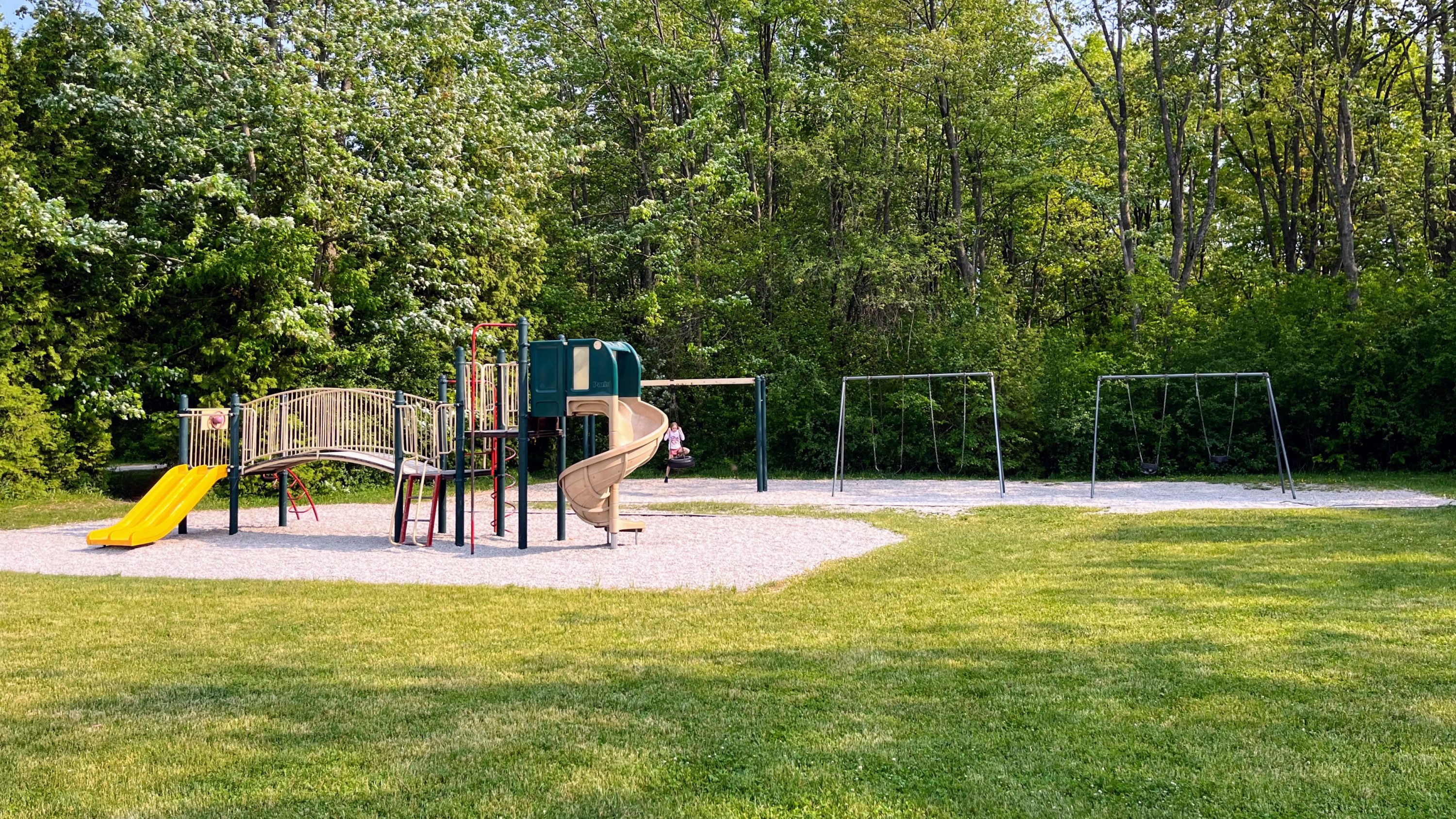 playground with three sets of swings